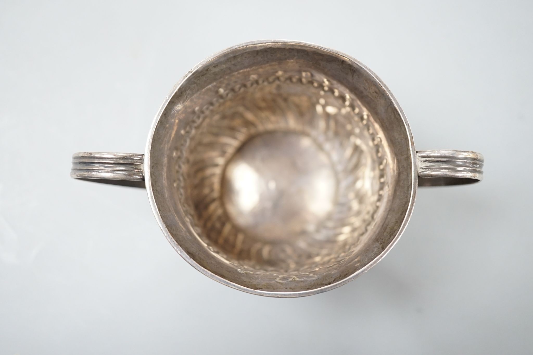 A George III embossed silver porringer, FM, London, 1766, 64mm, 79 grams.